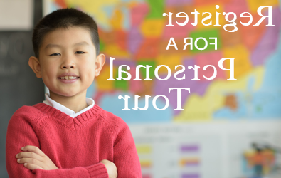 A student smiling while standing in a classroom at Dayspring Christian Academy.